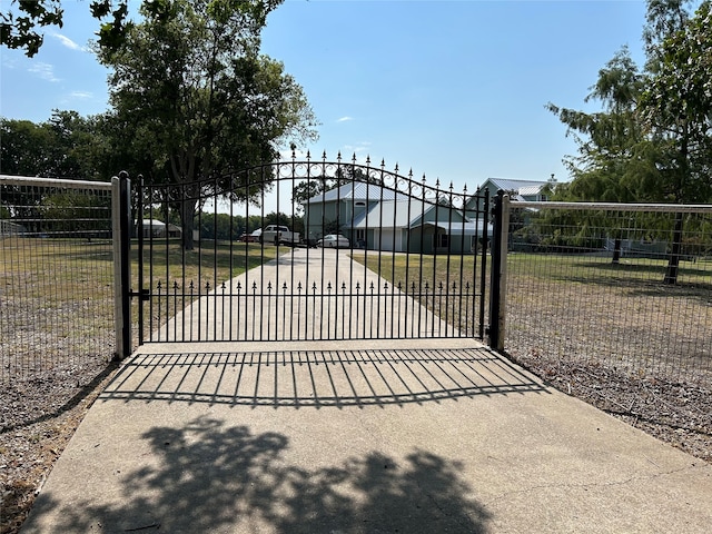 view of gate featuring a lawn