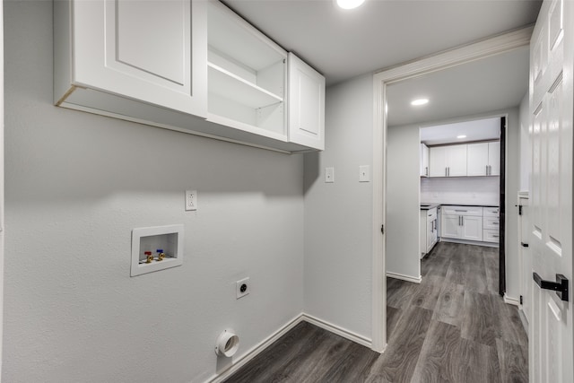 laundry area with dark hardwood / wood-style flooring, hookup for a washing machine, hookup for an electric dryer, and cabinets