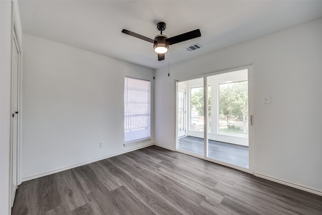 spare room featuring wood-type flooring and ceiling fan