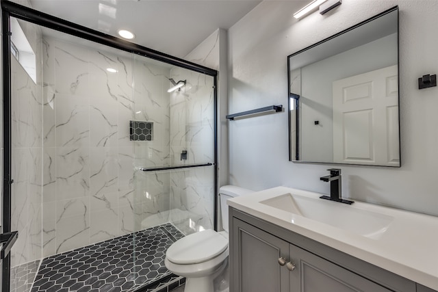 bathroom with an enclosed shower, vanity, and toilet