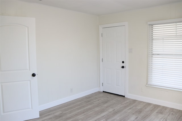 unfurnished room with light wood-type flooring