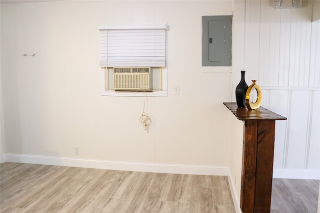 interior space with electric panel, cooling unit, and hardwood / wood-style floors