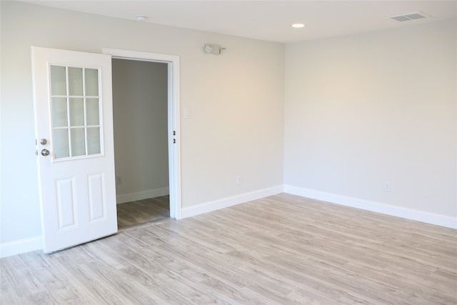 spare room featuring light hardwood / wood-style flooring