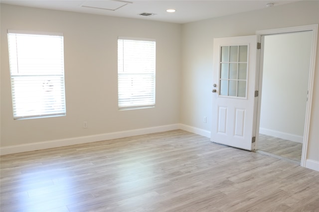 spare room featuring plenty of natural light and light wood-type flooring