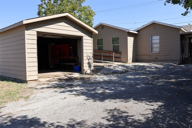 view of front of property with a garage and an outbuilding