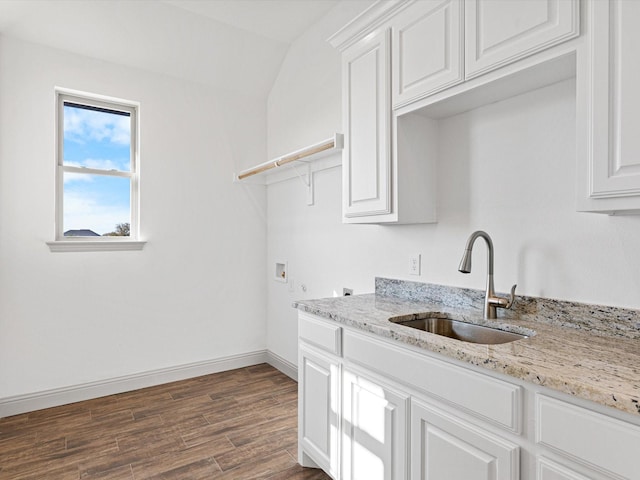 kitchen featuring sink, dark wood-type flooring, light stone countertops, and white cabinets