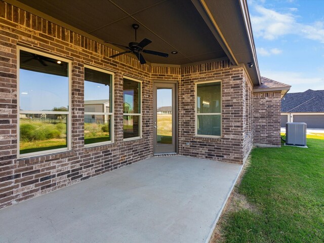 rear view of house with a patio, cooling unit, and a lawn