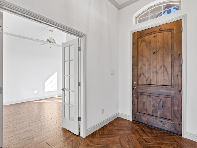 entrance foyer featuring crown molding, french doors, and ceiling fan