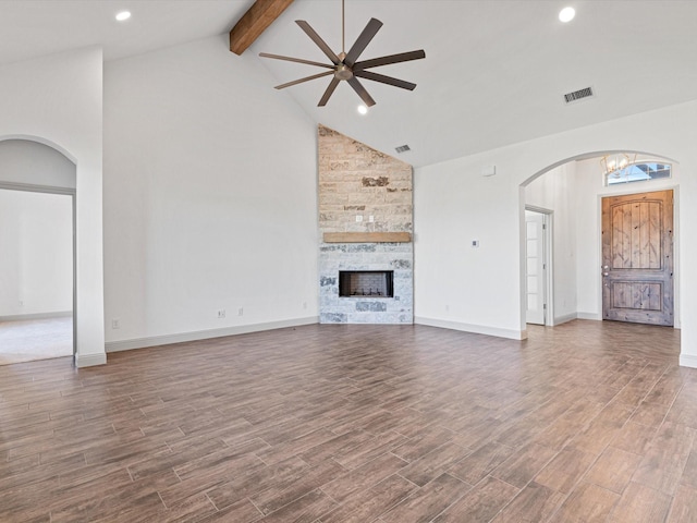 unfurnished living room with beamed ceiling, wood-type flooring, and a fireplace