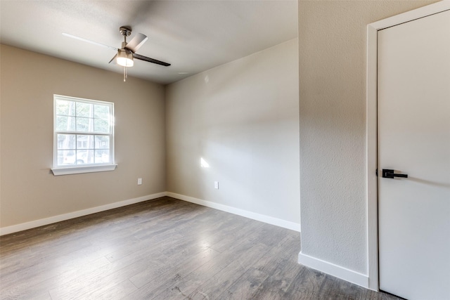 spare room with wood-type flooring and ceiling fan