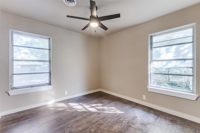 unfurnished room with dark hardwood / wood-style flooring, a wealth of natural light, and ceiling fan