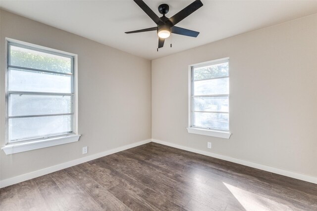 empty room with dark hardwood / wood-style flooring and ceiling fan