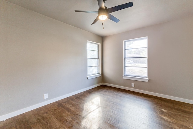 spare room featuring dark wood-type flooring and ceiling fan