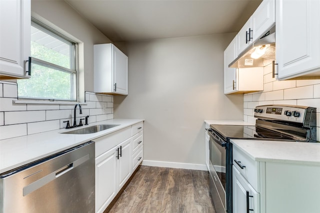 kitchen featuring stainless steel appliances, white cabinetry, sink, and tasteful backsplash