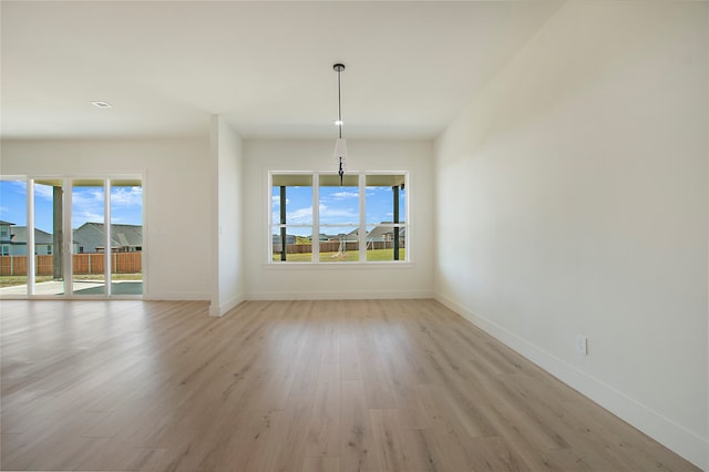 unfurnished dining area with light wood-type flooring