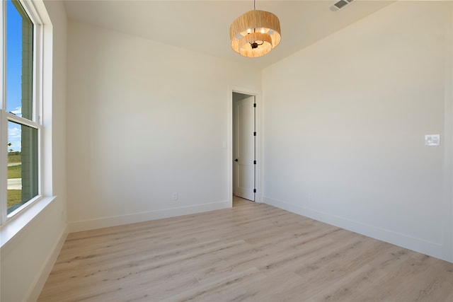 spare room featuring light wood-type flooring