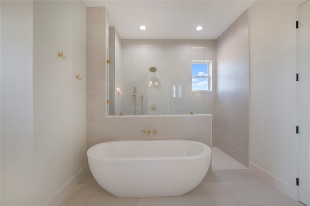 bathroom with tile patterned flooring and separate shower and tub