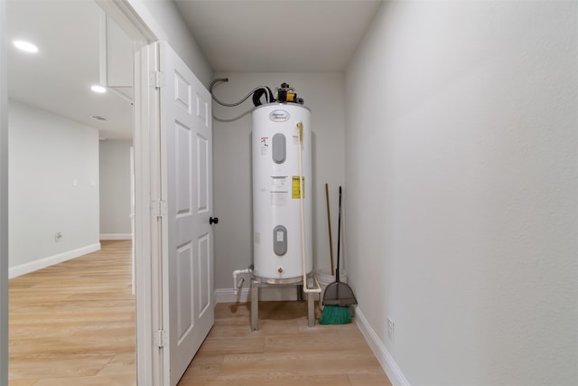 utility room with electric water heater