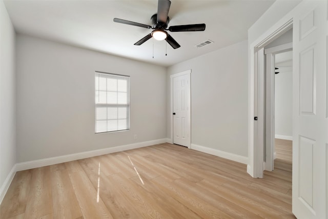 unfurnished bedroom featuring ceiling fan, light hardwood / wood-style flooring, and a closet