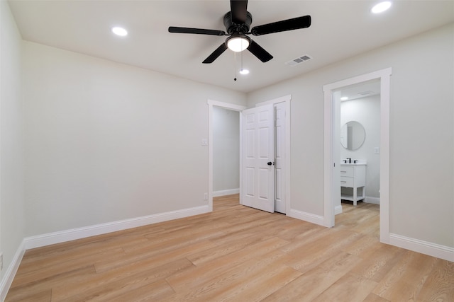 unfurnished bedroom with ensuite bathroom, ceiling fan, and light hardwood / wood-style floors