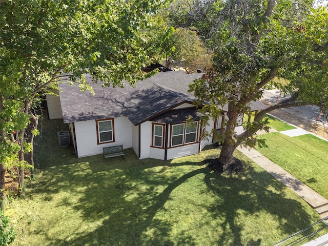 view of front of house featuring central AC unit and a front yard