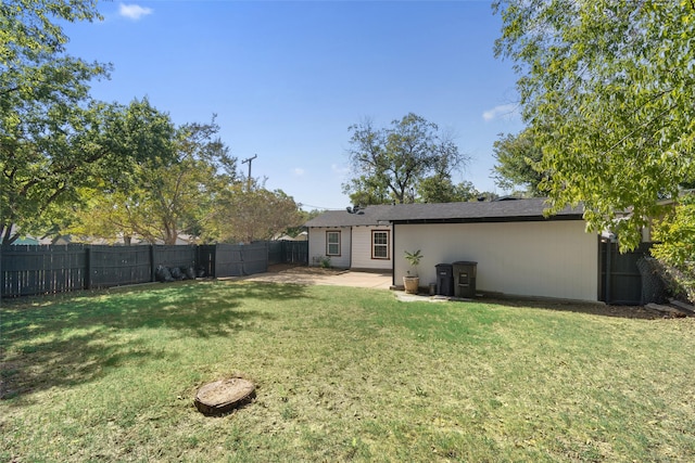 rear view of property featuring a yard and a patio area