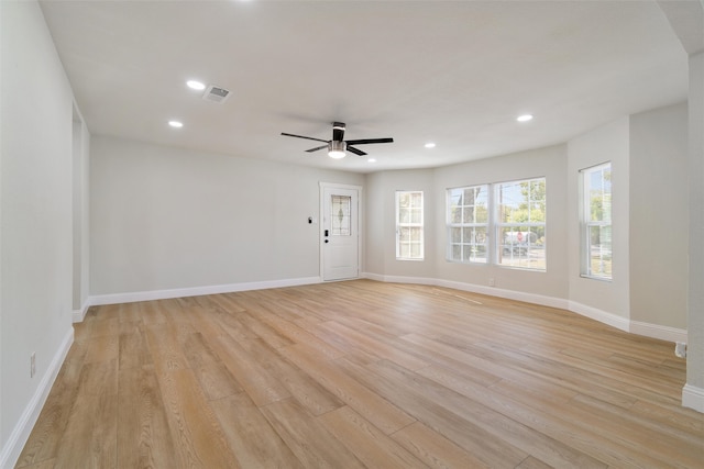 spare room with ceiling fan and light wood-type flooring