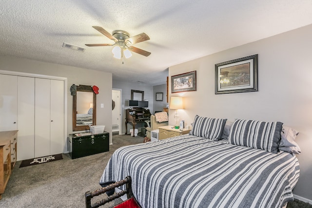 carpeted bedroom featuring ceiling fan, a closet, and a textured ceiling