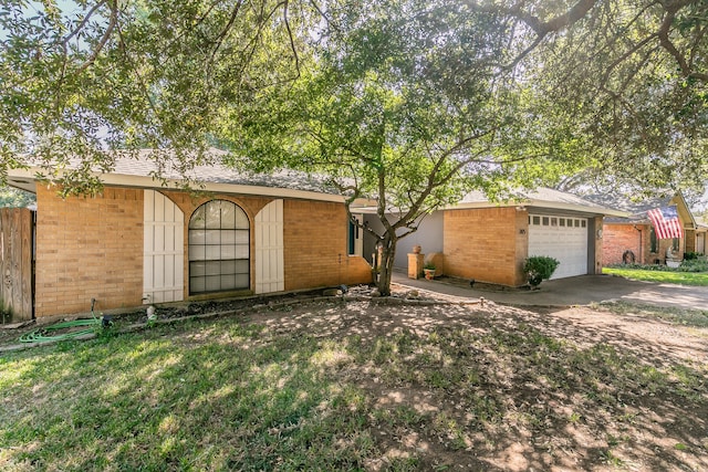 ranch-style house featuring a front yard and a garage