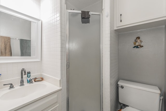 bathroom featuring walk in shower, toilet, decorative backsplash, vanity, and a textured ceiling