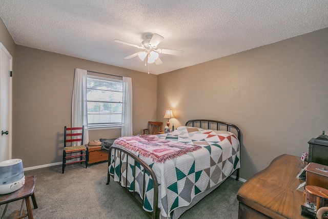 bedroom featuring dark carpet, a textured ceiling, and ceiling fan