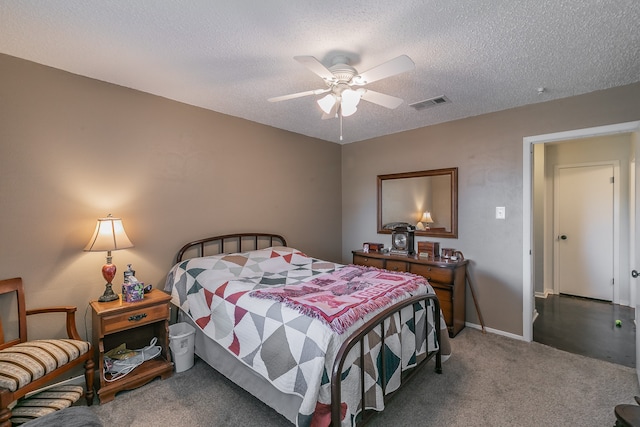 carpeted bedroom with a textured ceiling and ceiling fan