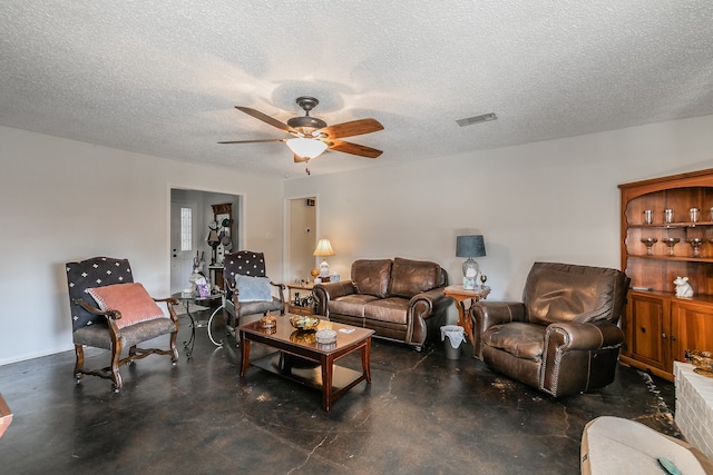 living room with ceiling fan and a textured ceiling