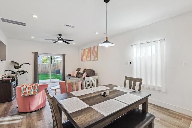 dining space with light hardwood / wood-style flooring and ceiling fan