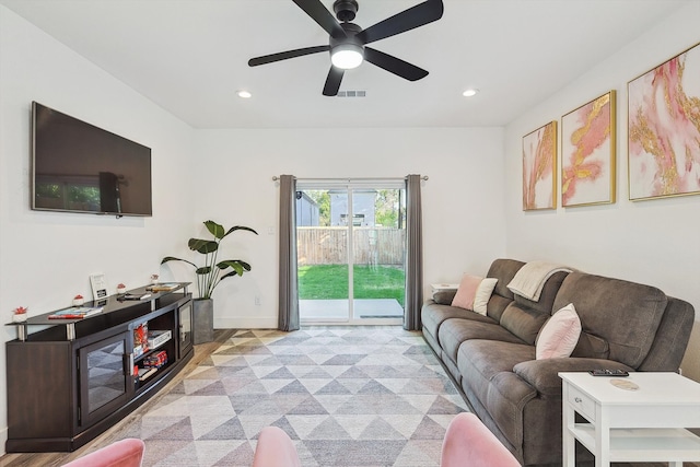 living room featuring ceiling fan and light wood-type flooring