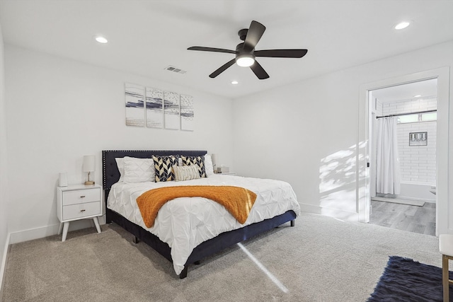 bedroom featuring ensuite bathroom, carpet floors, and ceiling fan