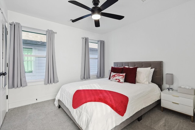 bedroom with multiple windows, light colored carpet, and ceiling fan