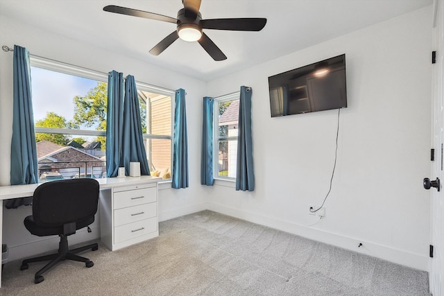 carpeted home office with ceiling fan