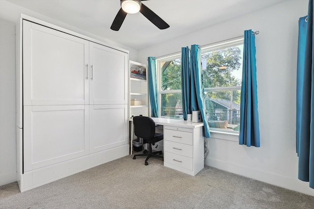 carpeted home office with ceiling fan