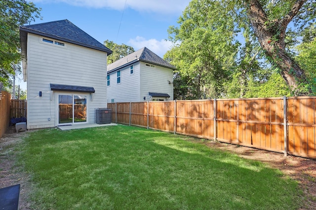 back of property with cooling unit and a lawn