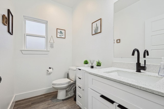 bathroom with vanity, hardwood / wood-style floors, and toilet