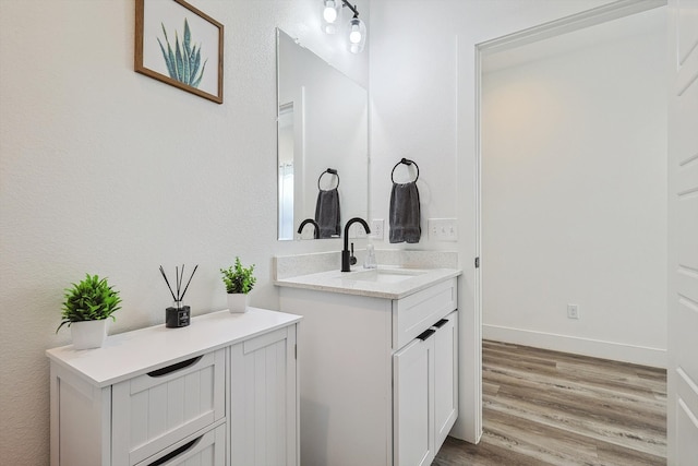 bathroom with vanity and wood-type flooring