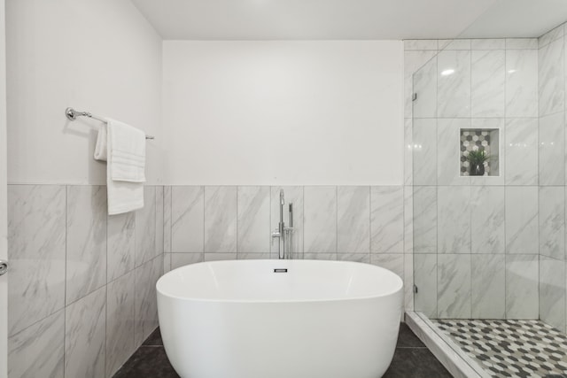 bathroom featuring tile patterned floors and tile walls