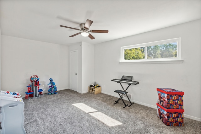 playroom with ceiling fan and carpet