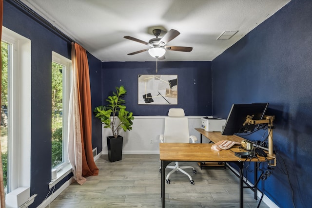 office featuring ceiling fan, wood-type flooring, and a textured ceiling