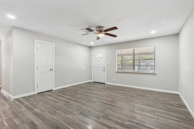 unfurnished room with ceiling fan and dark wood-type flooring