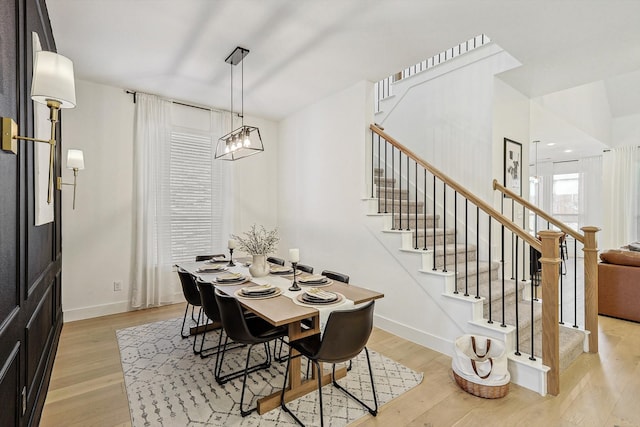 dining room featuring light wood-type flooring and a notable chandelier