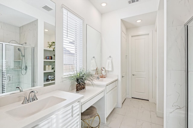 bathroom featuring an enclosed shower and vanity