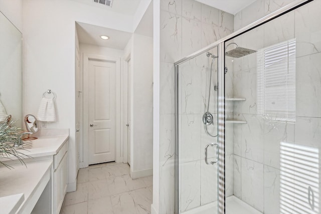 bathroom featuring vanity and a shower with door