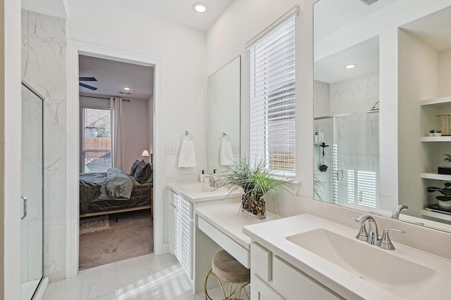 bathroom featuring vanity, ceiling fan, and a shower with shower door